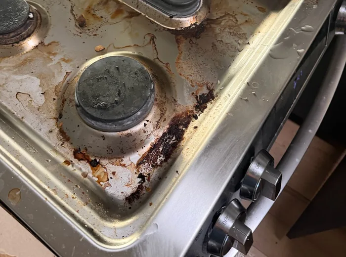 Greasy stovetop before a deep clean